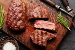 Grilled beef steaks on cutting board